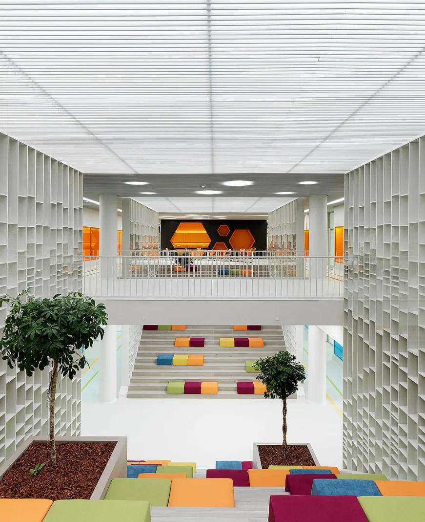 Bright white school atrium with colorful seating steps